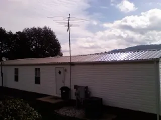 New metal roof on a single wide mobile home with a TV antenna in East Peoria